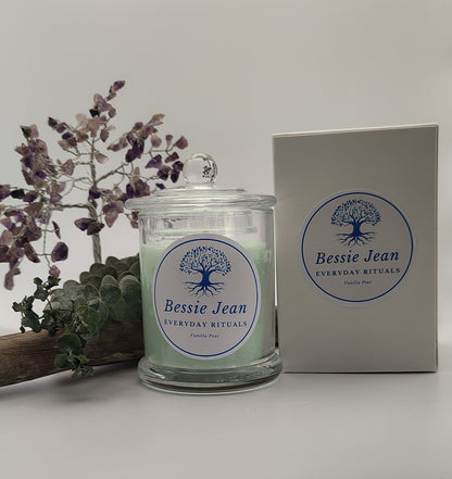 Bessie Jean candle with packaging and decorative elements on a white background